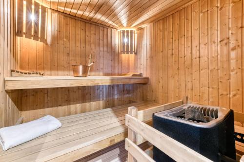a wooden sauna with a tub in it at Hôtel Lyret in Chamonix-Mont-Blanc
