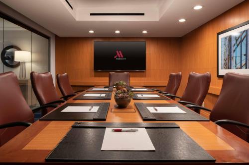 a conference room with a large table and a flat screen tv at San Francisco Marriott Fisherman's Wharf in San Francisco