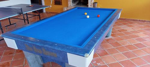 a pool table with two balls on top of it at Quinta Los Llanitos Hospedaje Campestre in Guatavita