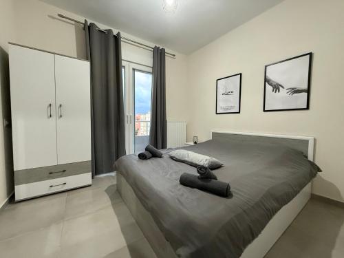 a bedroom with a large bed and a large window at Luffy's House in Alexandroupoli