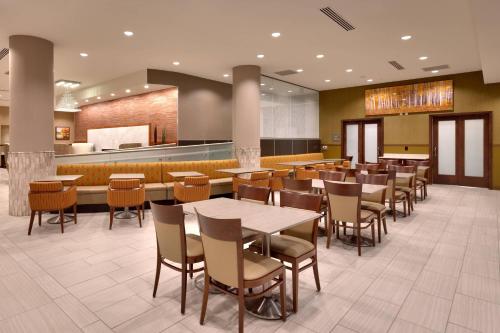 a restaurant with tables and chairs and a bar at Residence Inn by Marriott Flagstaff in Flagstaff