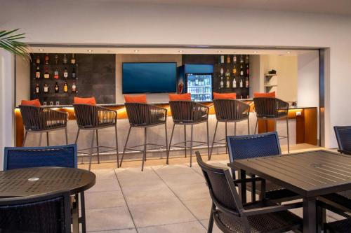 a restaurant with tables and chairs and a bar at SpringHill Suites By Marriott Frederick in Frederick