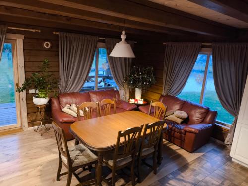 a living room with a table and a couch at Užmiesčio trobelė in Mackėnai