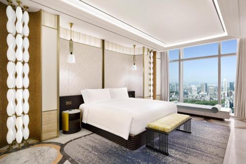 a bedroom with a white bed and a large window at Josun Palace, a Luxury Collection Hotel, Seoul Gangnam in Seoul