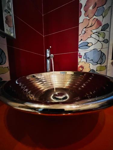 a metal sink in a bathroom with a tap at Sicilia Vacation rooms in Trapani