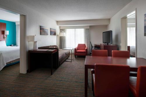 a hotel room with a bed and a living room at Residence Inn San Diego Del Mar in San Diego