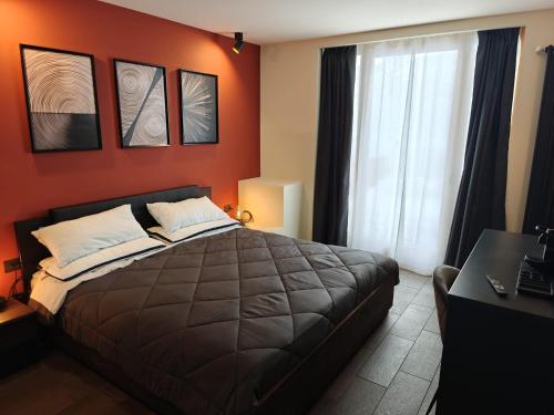 a bedroom with a large bed and a window at Hotel La Thuile Resort & SPA in La Thuile