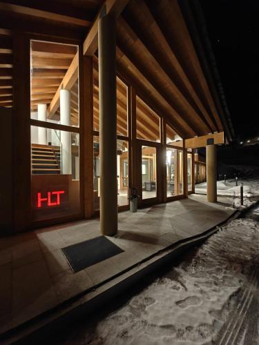 a building with columns and a lit sign on it at Hotel La Thuile Resort & SPA in La Thuile