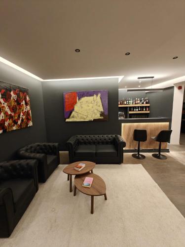 a living room with couches and a table and a bar at Hotel La Thuile Resort & SPA in La Thuile