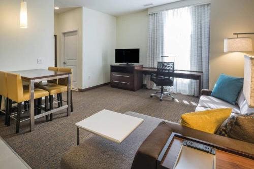 a living room with a couch a table and a desk at Residence Inn by Marriott Fishkill in Fishkill