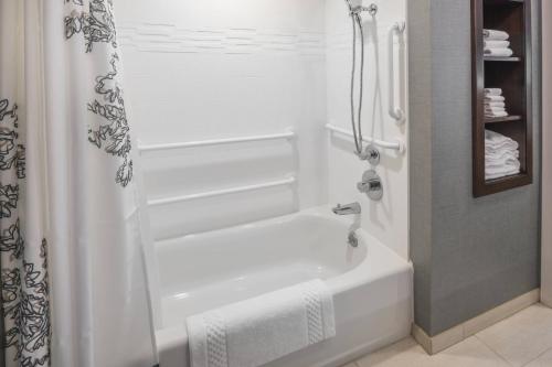a white bathroom with a shower and a tub at Residence Inn by Marriott Fishkill in Fishkill
