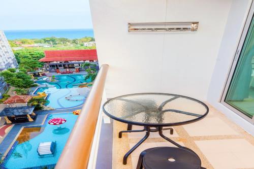 a table on a balcony with a view of a resort at Hua Hin First-Hin Nam in Hua Hin