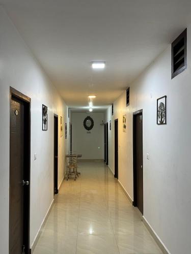 an empty hallway with doors and a table in a building at BanyanThree in Kodaikānāl