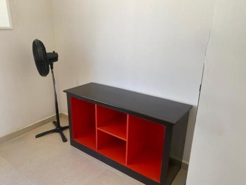 a black and red cabinet with a fan in a room at CASASANTA Fe cercalberca Wifi in Alpuyeca