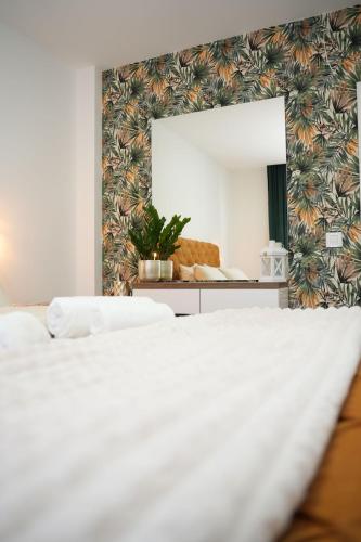 a bedroom with two beds and a large mirror at Apartman 28 in Arandjelovac
