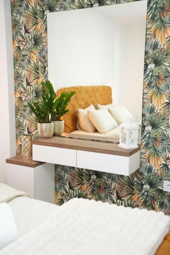 a bed in a bedroom with a wall at Apartman 28 in Arandjelovac