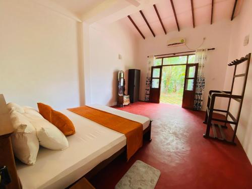 a bedroom with two beds and a large window at Villa Ocean Whisper in Induruwa