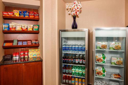 two refrigerators in a room with food and drinks at Residence Inn Long Island Holtsville in Holtsville