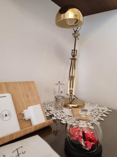 a desk with a lamp on top of a table at ROSSINI GUEST HOUSE in Martina Franca