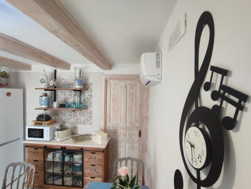 a kitchen with a clock on the wall at ROSSINI GUEST HOUSE in Martina Franca