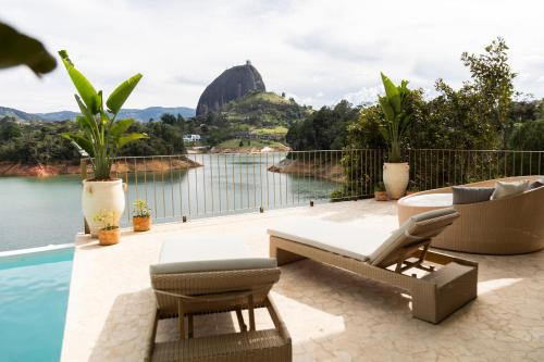 a patio with a view of a body of water at MYLOS Hotel Boutique in Guatapé