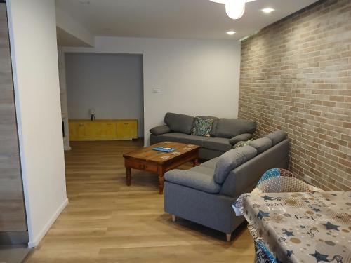 a living room with two couches and a coffee table at Cosy 4 Bedroom Apt with use of Pool in St Paul's Bay