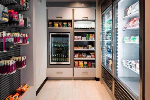 a refrigerator filled with lots of drinks at Residence Inn by Marriott Jersey City in Jersey City