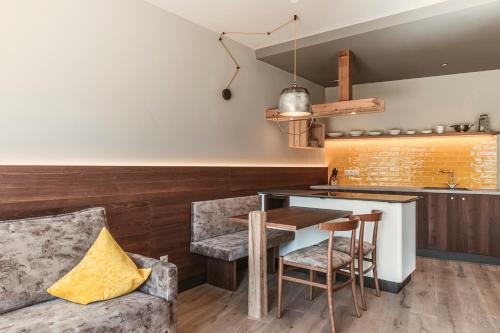 a kitchen with a table and chairs and a couch at Hosler in Merano