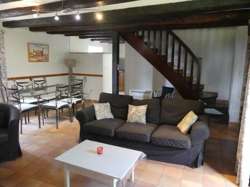 un salon avec un canapé et une table dans l'établissement La Maison de Jeanne, à Altillac