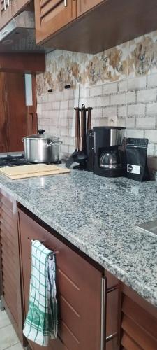 a kitchen with a counter top and a stove top oven at Квартира Olimbe in Yaoundé