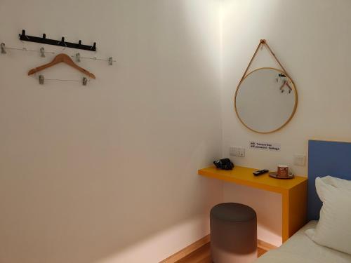 a room with a bed and a mirror on the wall at TREASURE BOX At Heritage Georgetown in George Town