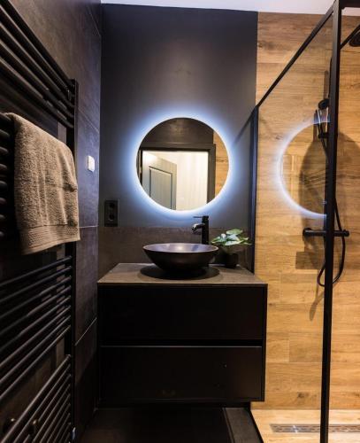 a bathroom with a sink and a mirror at Haya Historic - Shiraz in The Hague