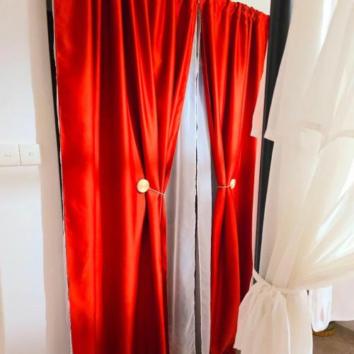 a red curtain is hanging in a room at Kozakos Luxury House in Pano Lefkara