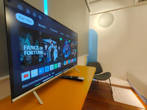 a flat screen tv sitting on top of a table at TREASURE BOX At Heritage Georgetown in George Town