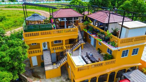 an overhead view of a yellow house with a balcony at Sunlandvilla in Portmore