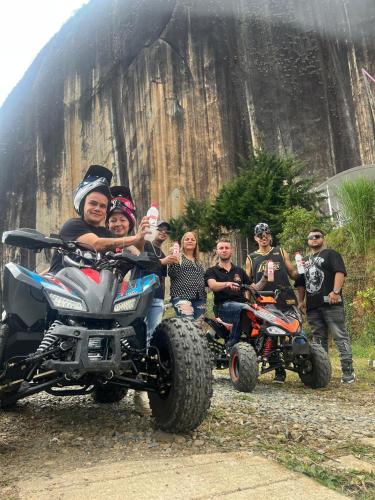 a group of people posing for a picture in front of a four wheeler at Hotel Bahia Del Faro in Guatapé