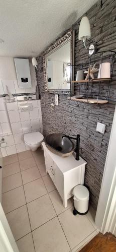 a bathroom with a sink and a toilet at Ferienhaus Hof in Remscheid