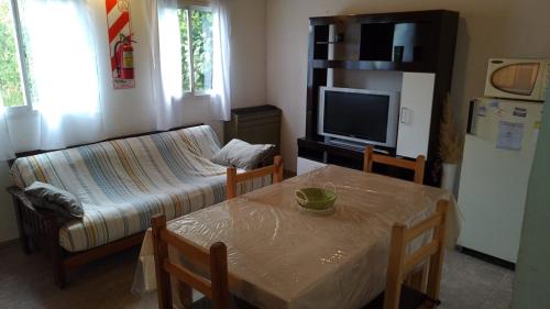 a living room with a table and a couch at Departamento por día ruta 41 in Los Antiguos