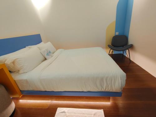 a bedroom with a bed and a chair in it at TREASURE BOX At Heritage Georgetown in George Town
