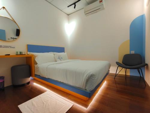 a bedroom with a bed and a desk and a chair at TREASURE BOX At Heritage Georgetown in George Town