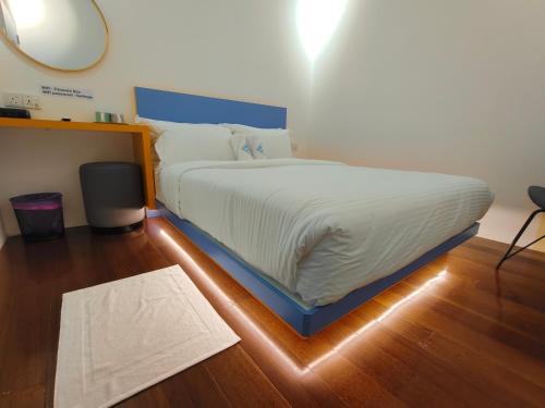 a large bed in a room with a wooden floor at TREASURE BOX At Heritage Georgetown in George Town