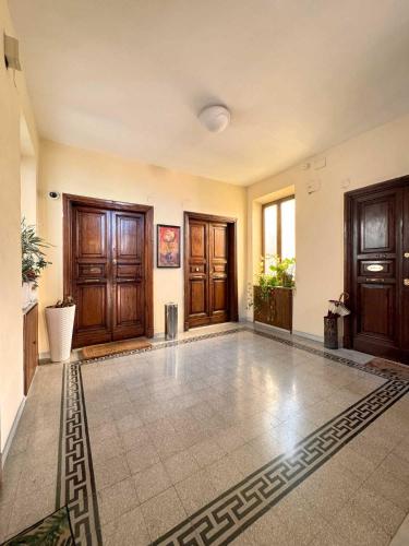 a large room with wooden doors and a tile floor at Piramide Suites 2 Bedrooms & 2 Bathrooms in Rome