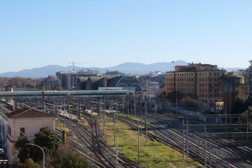 a view of a city with train tracks and buildings at Piramide Suites 2 Bedrooms & 2 Bathrooms in Rome