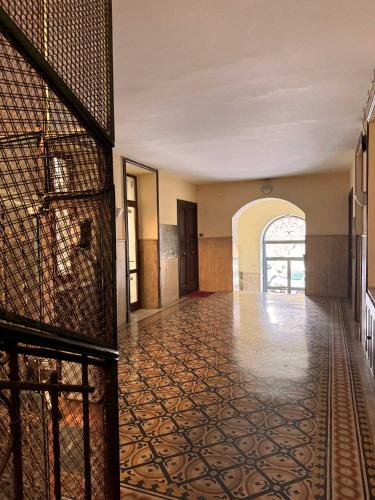 an empty room with a hallway with a tile floor at Piramide Suites 2 Bedrooms & 2 Bathrooms in Rome