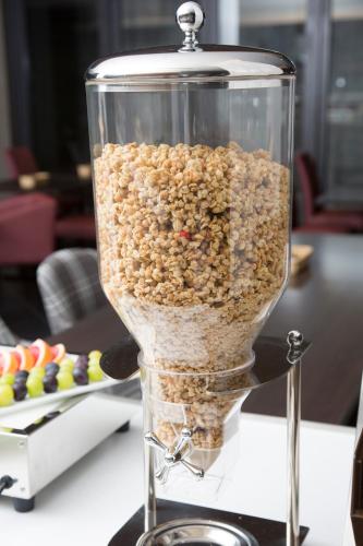 a glass container filled with nuts on a table at Urban Hotel Kyoto Nijo Premium in Kyoto