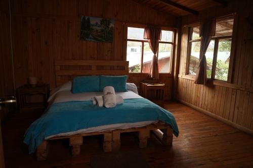 a bedroom with a bed with a stuffed animal on it at Mindo GlamBird Glamping & Lodge in Mindo