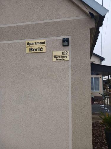 a sign on the side of a building that says april antique battle at Apartmani Beric in Bogatić