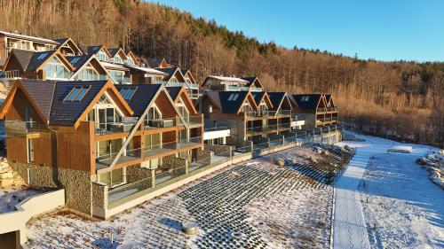 an aerial view of a row of houses in the snow at Kras-Resort Apartament 301 i 303 z widokiem na góry, prywatnym jacuzzi na tarasie i sauną in Szklarska Poręba