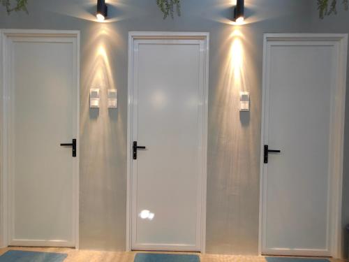 two doors in a room with lights on the wall at TREASURE BOX At Heritage Georgetown in George Town