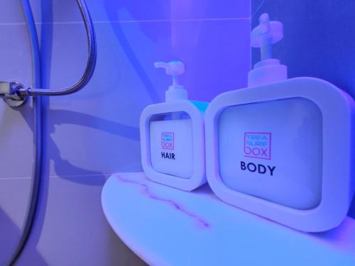 a bathroom with a toilet and a shower with a box ofody at TREASURE BOX At Heritage Georgetown in George Town